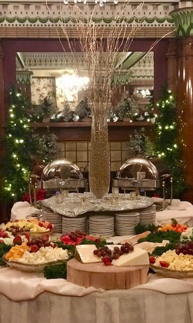 Cheese, fruit, and vegetable display in the Fireplace banquet room at The Corinthian Event Center decorated for Christmass.
