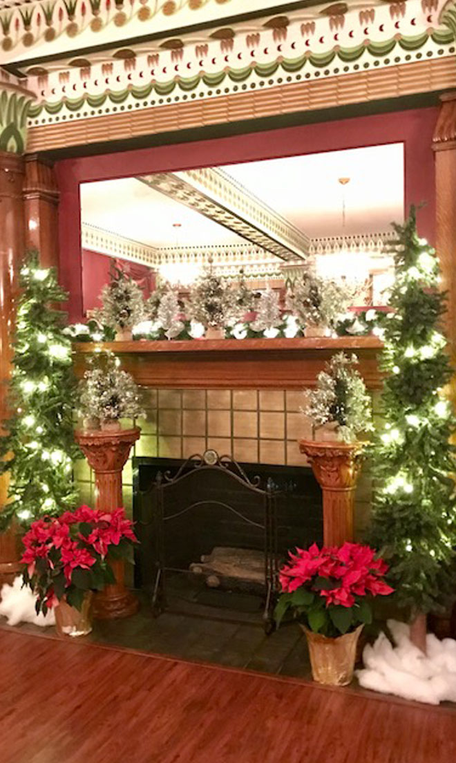 Fireplace banquet room at The Corinthian Event Center decorated for Christmass.