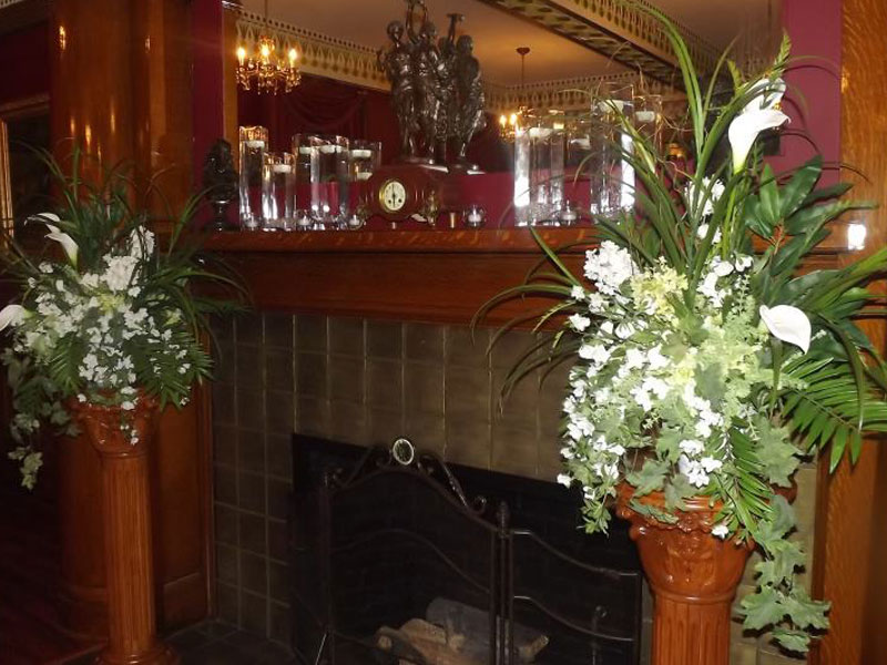 Flowers at the fireplace in the Fireplace banquet room at The Corinthian Event Center.