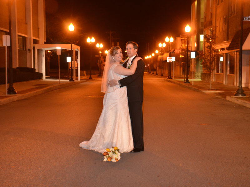 Bride and Groom on street at night in beautiful downtown Sharon PA near The Corinthian Event Center.