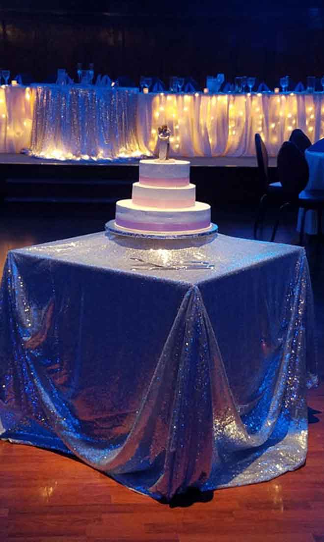 Cake table place setting with blue and pink decor at The Corinthian Event Center.