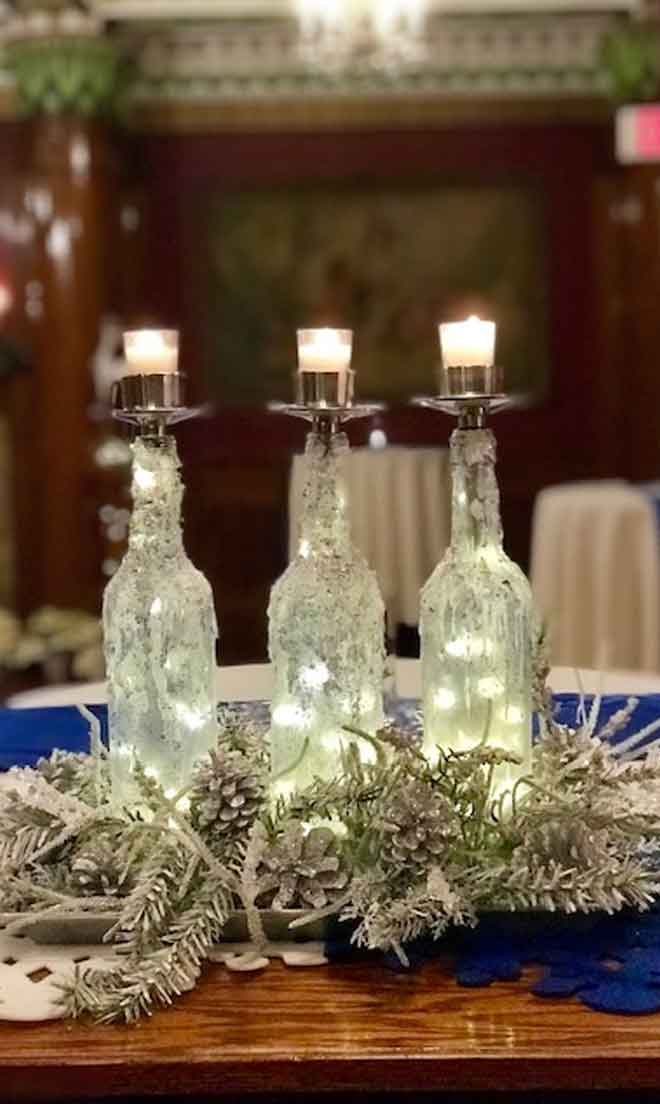 Lighted candle holder centerpiece decor at The Corinthian Event Center.