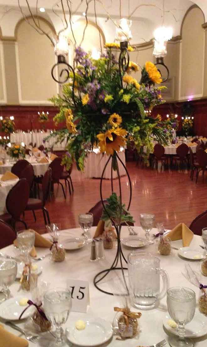 Sunflower centerpiece and place setings at The Corinthian Event Center.