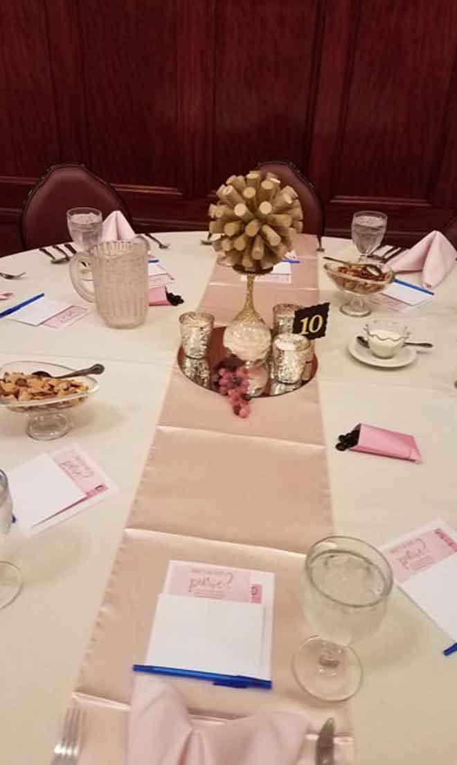 Corporate table centerpiece in white and pink theme at The Corinthian Event Center.