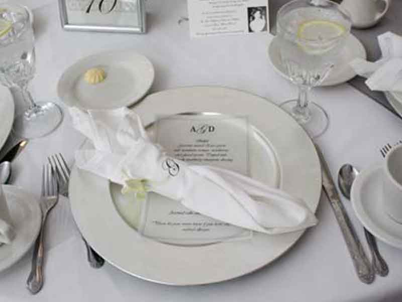 White place place settings at The Corinthian Event Center.
