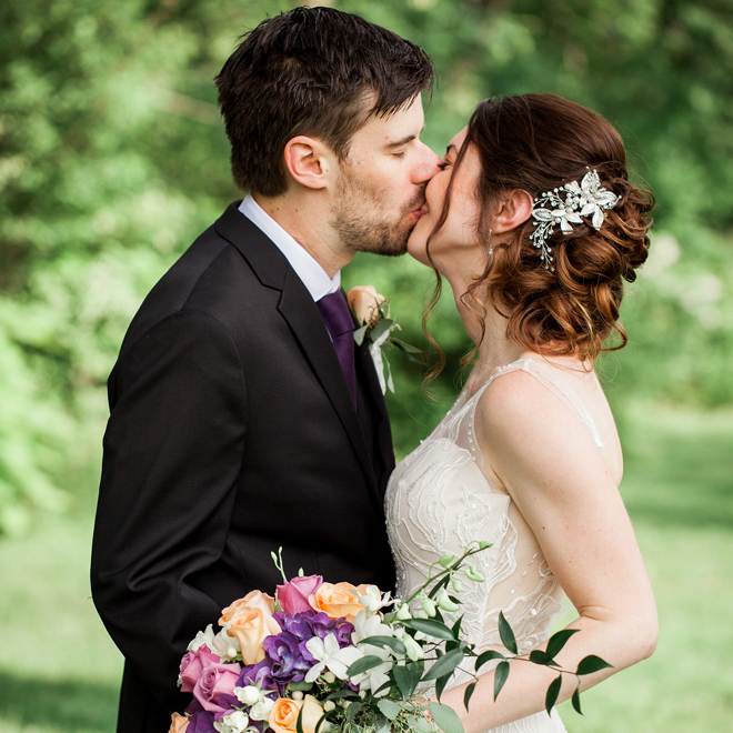 Bride and groom kiss at The Corinthinan Events Center.